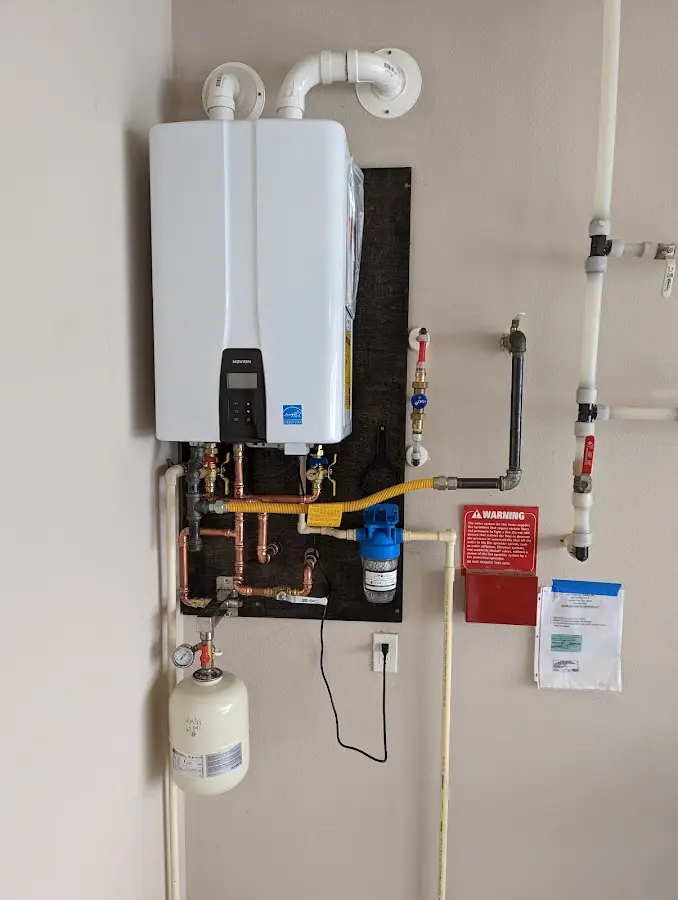 Professional plumber installing copper piping in a Fox River Grove home